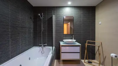 a bathroom with a bath tub and a sink at VilamouraSun Aquamar 110 - Pool and Marina View in Vilamoura