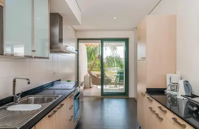 a kitchen with a sink and a counter top at VilamouraSun Aquamar 110 - Pool and Marina View in Vilamoura