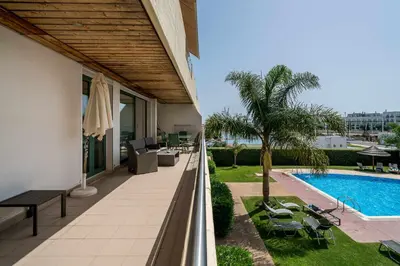 a balcony of a house with a swimming pool at VilamouraSun Aquamar 110 - Pool and Marina View in Vilamoura