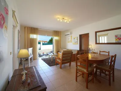 a living room with a table and a dining room at Holiday Home Monte Novo by Interhome in Paderne