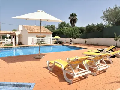 a swimming pool with two lounge chairs and an umbrella at Holiday Home Monte Novo by Interhome in Paderne
