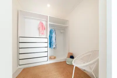 a bedroom with a white closet with a crib at Vila dos Lírios - Blue Sea in Albufeira