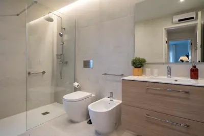 a bathroom with a shower and a toilet and a sink at Solar do Golfe apt 101 - By Vilamoura Sun in Vilamoura
