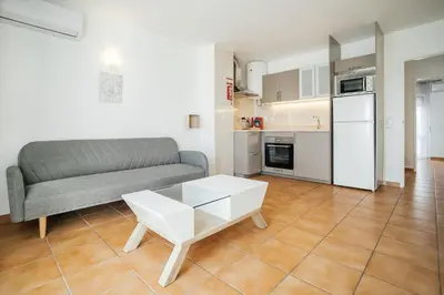 a living room with a couch and a table at Oura Parque Apartamentos Turisticos in Albufeira