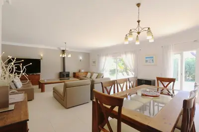 a living room with a table and a dining room at Villa Corvo 123- Clever Details in Vilamoura