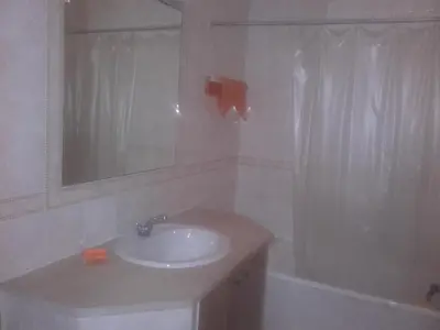 a bathroom with a sink and a mirror and a tub at Albufeira INN - Elimar 3 T1 in Albufeira