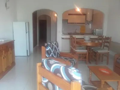 a living room with a kitchen and a dining room at Albufeira INN - Elimar 3 T1 in Albufeira