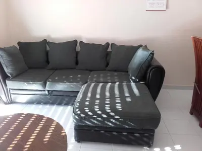 a black couch and an ottoman in a living room at Albufeira INN - Elimar 5 T1 in Albufeira