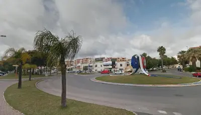 a street with a tree in the middle of a road at Albufeira INN - Elimar 5 T1 in Albufeira