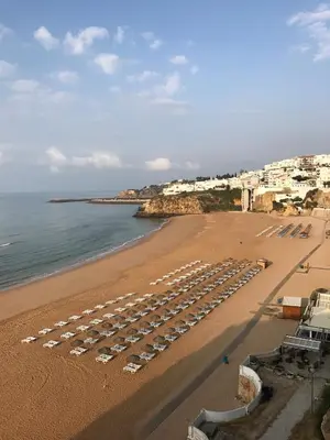 a beach with a bunch of umbrellas and the ocean at Casa 