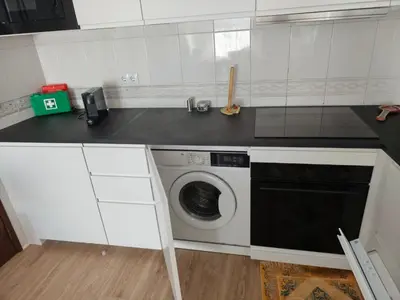 a kitchen with a washing machine in a kitchen at Praia dos Aveiros T1 - Albufeira INN in Albufeira