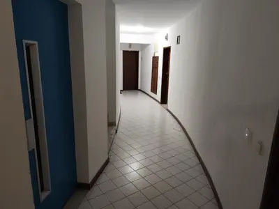 an empty hallway with a tile floor and a corridorngthngthngthngthngthngth at Praia dos Aveiros T1 - Albufeira INN in Albufeira