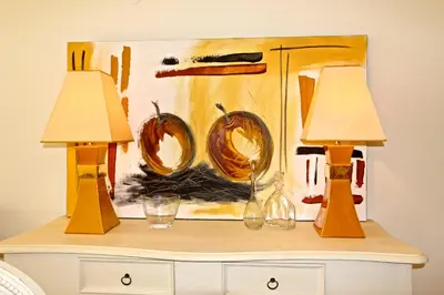 two lamps on top of a dresser with a painting at Moura Praia - Clever Details in Vilamoura