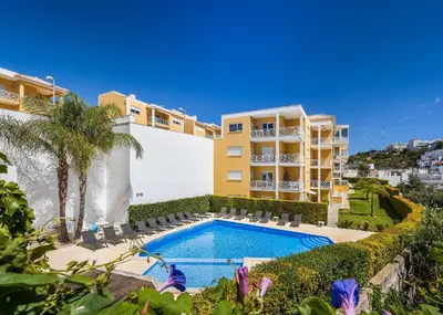 an apartment with a swimming pool and a building at Garden Hill Relax & Old Town by OCvillas in Albufeira
