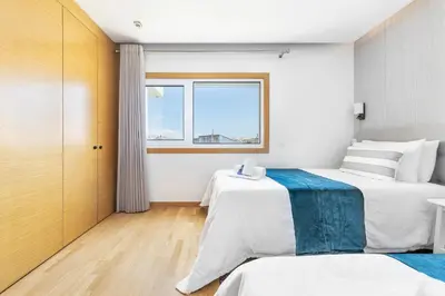 a hotel room with two beds and a window at Garden Hill Relax & Old Town by OCvillas in Albufeira
