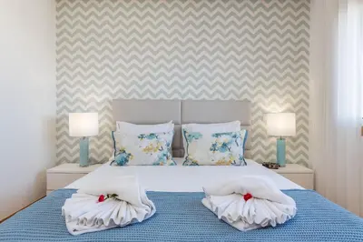 a bedroom with a bed with two pillows on it at Garden Hill Relax & Old Town by OCvillas in Albufeira