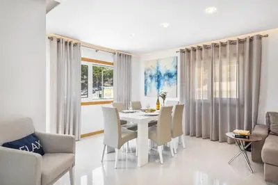 a dining room with a white table and chairs at Garden Hill Relax & Old Town by OCvillas in Albufeira