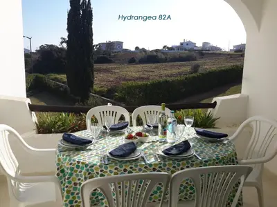 a bedroom with two beds and a table with a lamp at Apartamentos São Rafael - Albufeira, Algarve in Albufeira