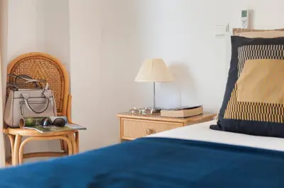 a bedroom with a bed and a table with a lamp at Vila dos Girassóis - BlueSea in Albufeira