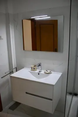a bathroom with a white sink and a mirror at Encosta das Oliveiras 49D in Vilamoura