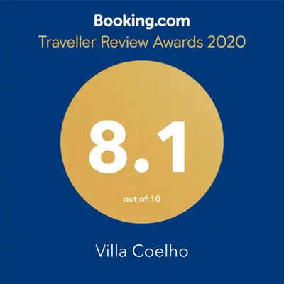 a yellow circle with the number eight and the text travelling review awards at Villa Coelho - By Algarkasa in Albufeira