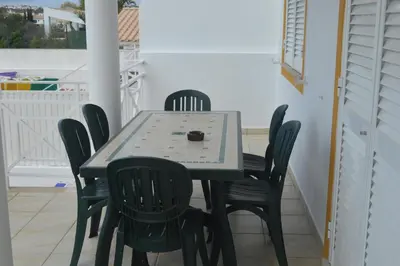 a table and chairs in a room with a table and chairsktop at Villa Coelho - By Algarkasa in Albufeira