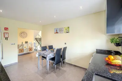 a kitchen and dining room with a table and chairs at Villa Monica - POOL HEATED - By Algarkasa in Albufeira
