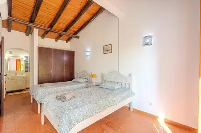 two beds sitting in a room with a room with at Villa Amendoeira-POOL HEATED - By Algarkasa in Guia