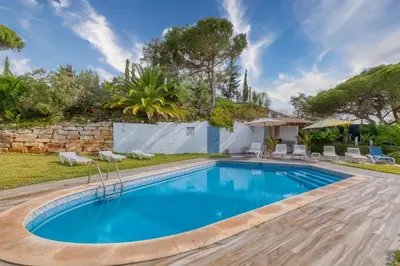 a swimming pool in the backyard of a house at Casa Teles in Quarteira