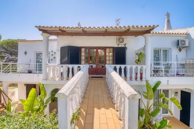 a house with a staircase leading to the front door at Casa Teles in Quarteira