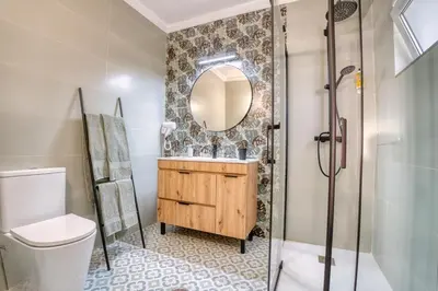 a bathroom with a shower and a sink and a toilet at Casa Teles in Quarteira