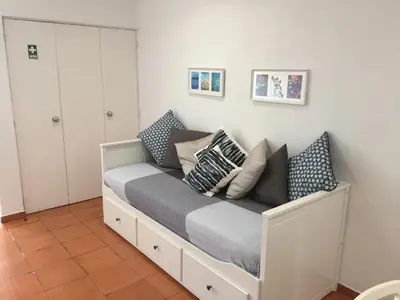 a bed with pillows on it in a room at Charmosous Flat in Albufeira