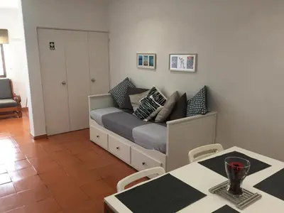 a bedroom with a bed with pillows on it at Charmosous Flat in Albufeira