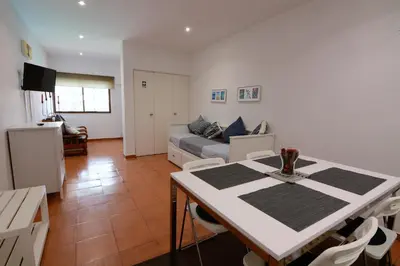 a living room with a table and a couch at Charmosous Flat in Albufeira