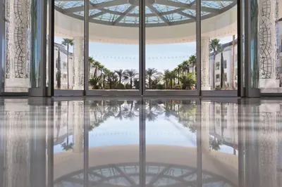 a rendering of the lobby of a building with a reflection in the water at Conrad Algarve in Quinta do Lago