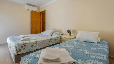 a bedroom with two beds with towels on them at Villa Girassol in Vilamoura