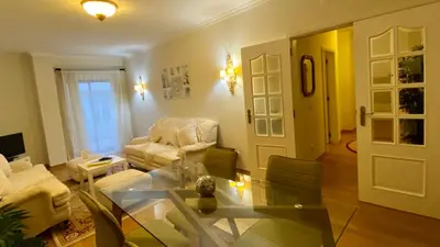 a living room with a glass table and chairs at Downtown by Check-in Portugal in Faro