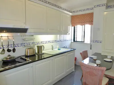 a kitchen with white cabinets and a sink at Downtown by Check-in Portugal in Faro