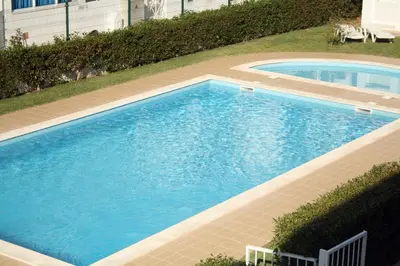 an overhead view of a large blue swimming pool at Apartamentos King's in Quarteira