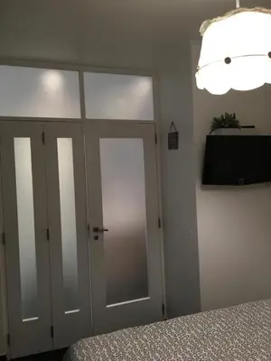 a bedroom with a bed and a sliding glass door at Estúdio tranquilo praia da Falésia in Albufeira