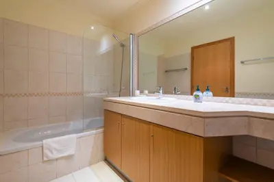 a bathroom with a sink and a bath tub at Vista das Ondas by Algarneto in Albufeira