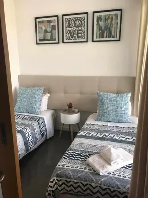 a bedroom with two beds and a small table at Marina Vilamoura - Aquamar 401- Modern Apartment in Vilamoura