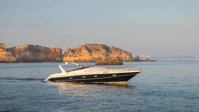 a black and white boat in the water at Marina Vilamoura - Aquamar 401- Modern Apartment in Vilamoura