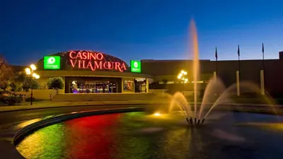 a building with a fountain in front of a restaurant at Marina Vilamoura - Aquamar 309 By Vilamoura Sun in Vilamoura