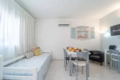 a small living room with a table and chairs at Lena`s Beach House by HelloVacations in Albufeira