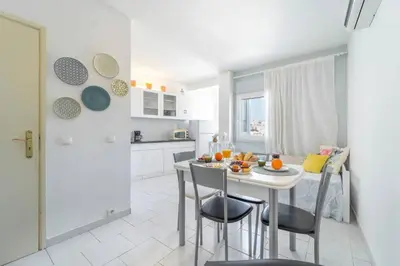 a kitchen with a table and chairs in a room at Lena`s Beach House by HelloVacations in Albufeira