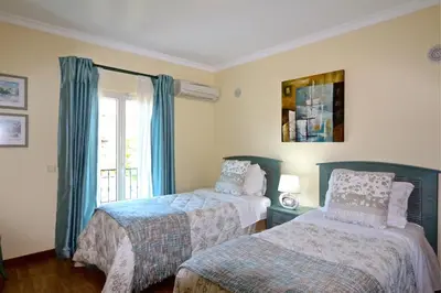 a bedroom with two beds and a window at Villa Heloise 139 - Clever Details in Vilamoura