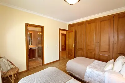 a bedroom with two beds and a bathroom at Villa Heloise 139 - Clever Details in Vilamoura