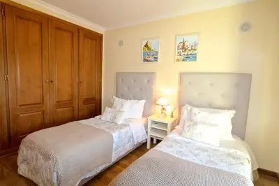 a bedroom with two beds and a night stand at Villa Heloise 139 - Clever Details in Vilamoura