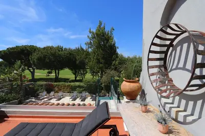 a view of a patio with a chair and a mirror at Villa Bonito 56 - Clever Details in Vilamoura